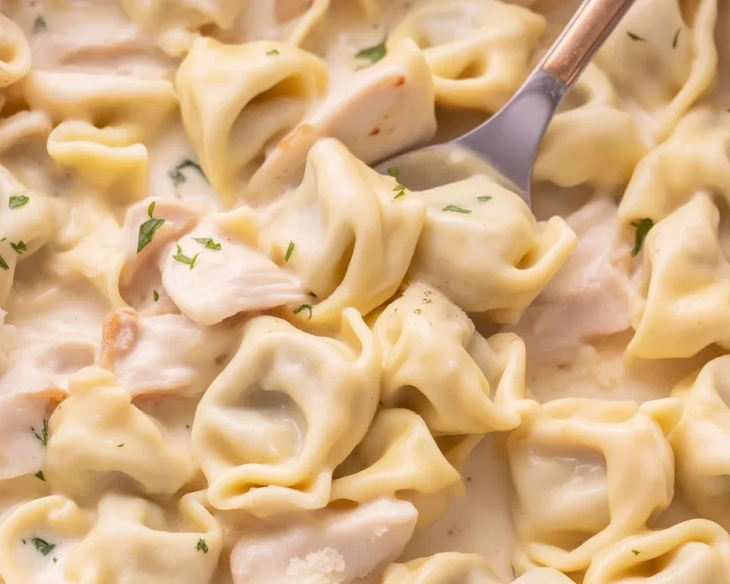 Delicious Garlic Parmesan Chicken Tortellini served in a creamy sauce with fresh herbs.